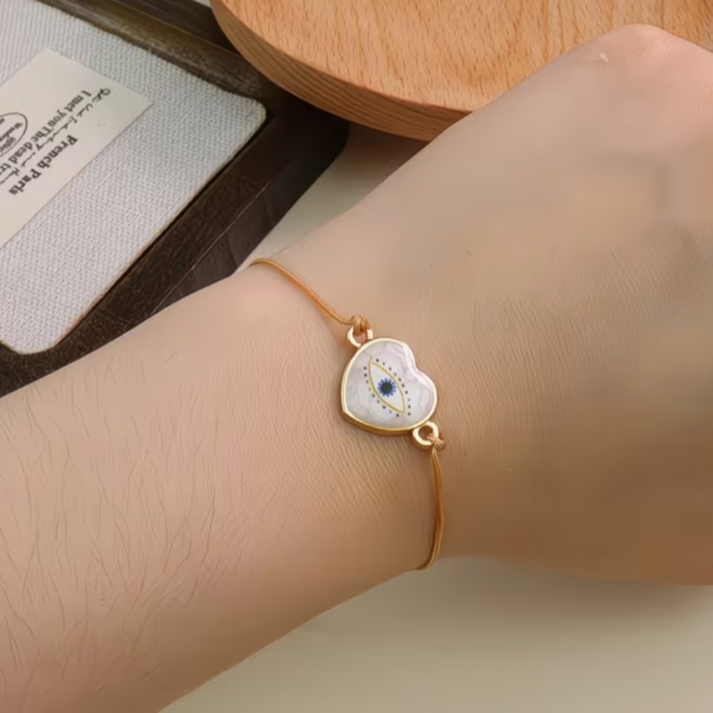 Gold and Pearlized Heart Evil Eye Adjustable Rope Bracelet - Picture 1 of 3